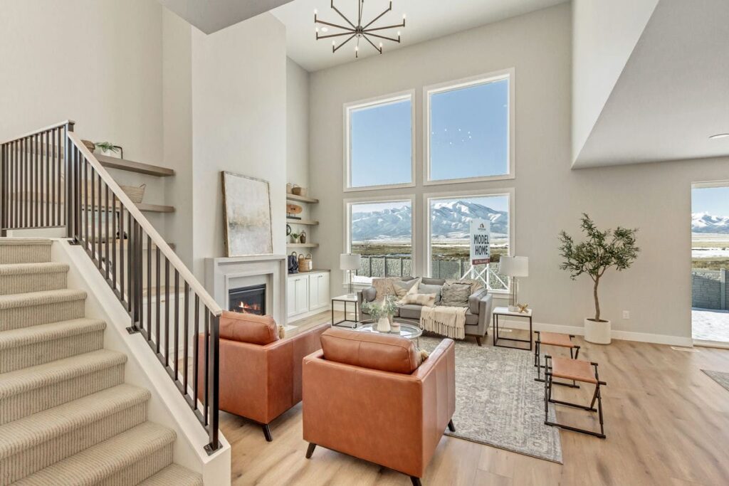 A cozy living room with a staircase leading to the second floor.